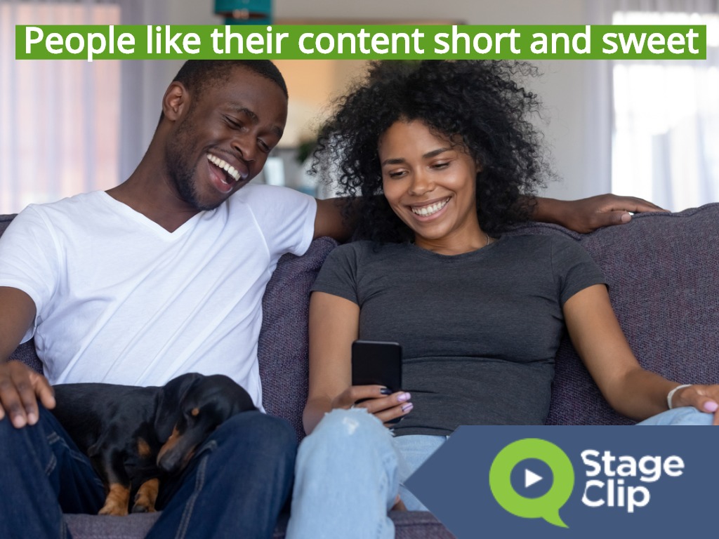 happy-black-couple-with-pet-laughing-looking-at-smartphone-picture-id1126384538
